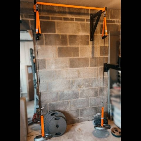 Lift and press Home Gym Equipment photo sent in by customer showing the heavy duty pull up bar with cable cross over machine set in in garage